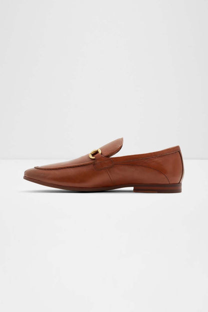 Cognac penny loafer with gold hardware, smooth vamp, and low sole
