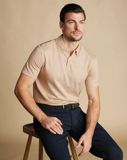 Charles Tyrwhitt polo shirt on model, light tan short sleeves