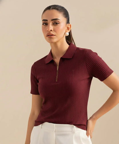 Fitted maroon ribbed knit polo top with short sleeves, collar, and gold-tone half-zip