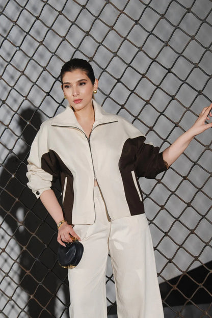 Beige zip-up jacket with dark brown panels, stand collar, and side pockets