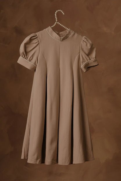 Stone babydoll dress with round neckline, puff sleeves, and pleated front