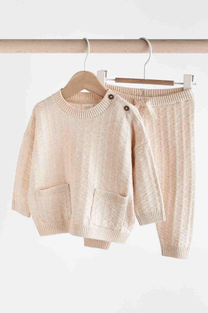 Baby knit sweater and pants set, light pink textured sweater and ribbed pants on hangers