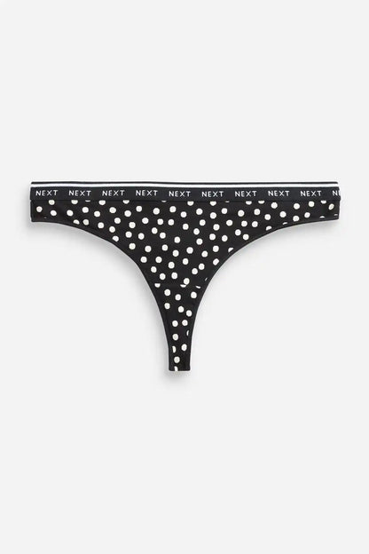 Black thong with all-over white polka dots and branded waistband