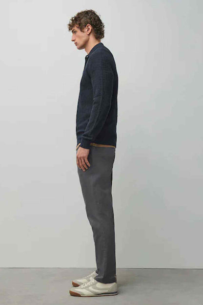 Dark grey chino trousers side view with belt loops and tapered legs