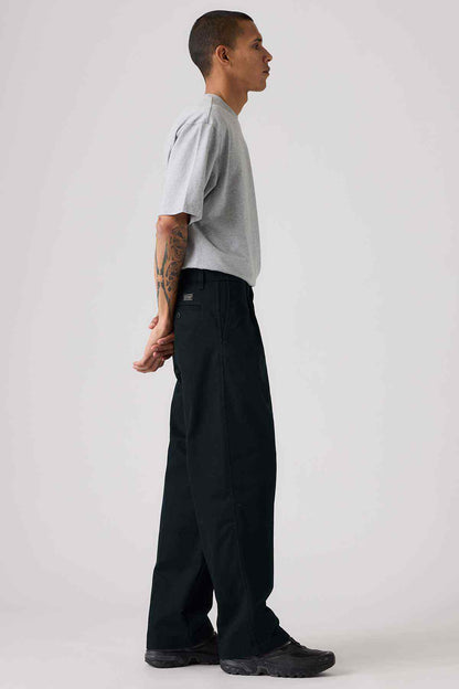 Levi's black wide-leg pants with gray crew-neck T-shirt, side view