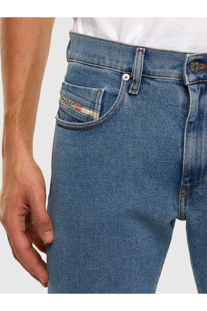 Blue denim jeans front with curved pockets and a stitched coin pocket.