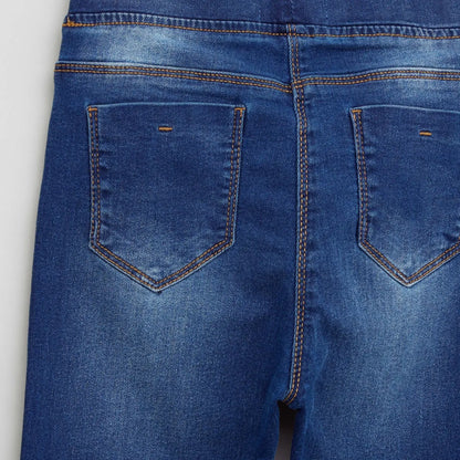 BABYSHOP blue denim jeans close-up: rear pockets with orange topstitch