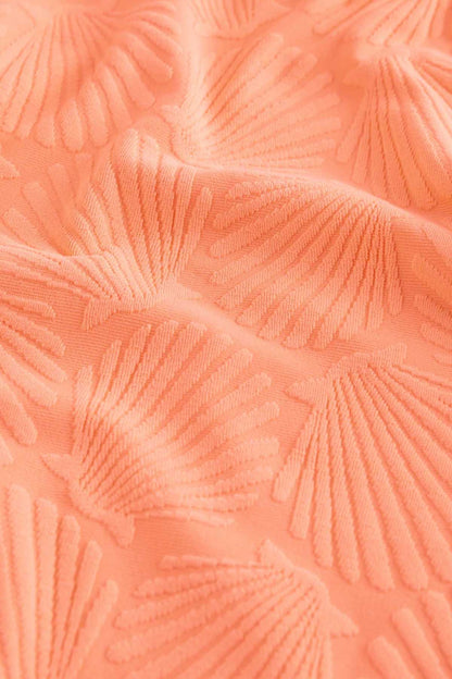 Orange textured fabric with raised leaf/fan pattern for a swimsuit