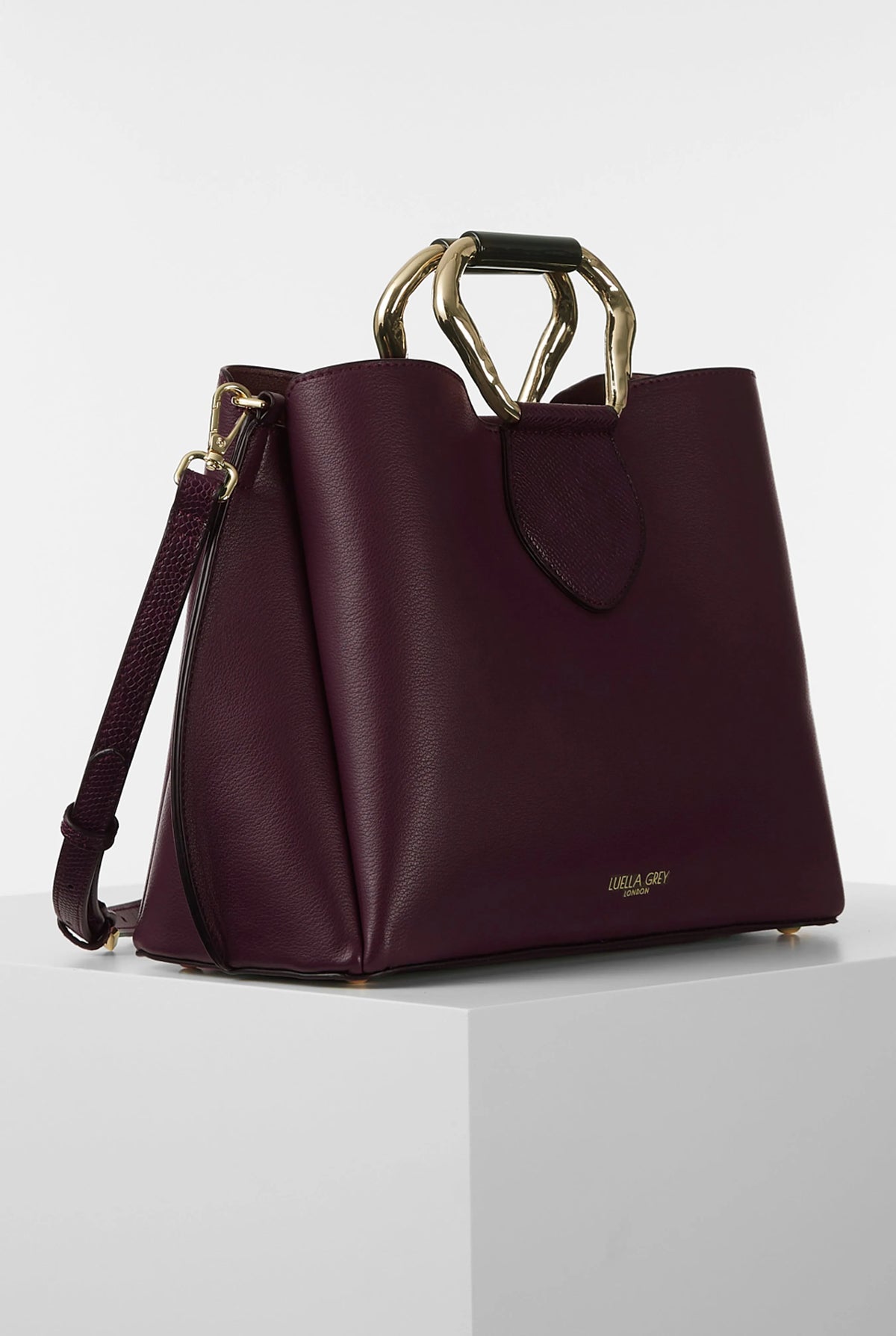 Dark purple structured handbag with top handle ring and detachable shoulder strap