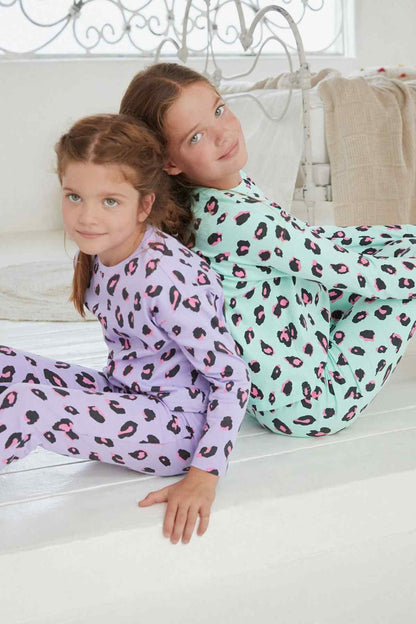 Leopard-print long-sleeve pajamas in purple and mint, kids kneeling and stretching