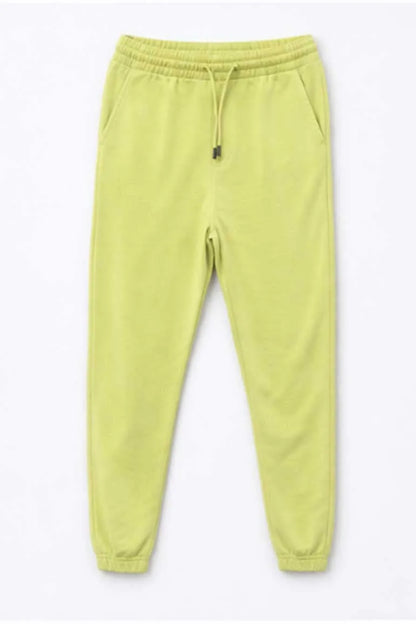Green sweatpants with elastic drawstring waist and cuffed ankle hems