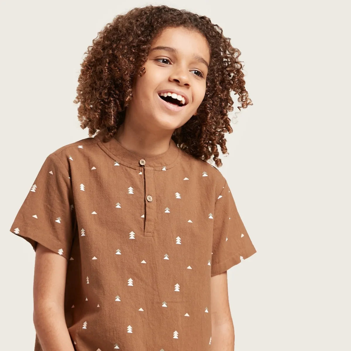 Brown short-sleeve kids shirt with button placket and white printed tree pattern