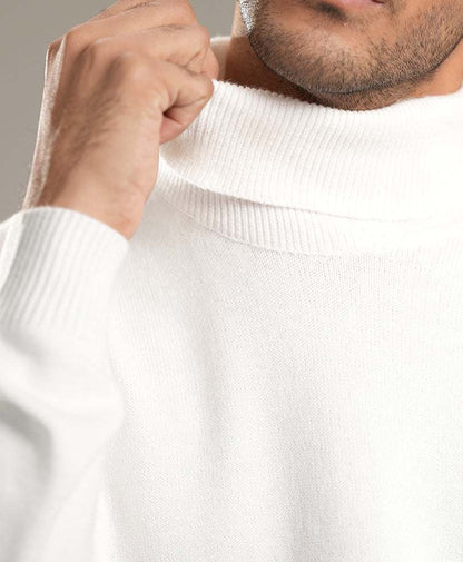White turtleneck sweater close-up of ribbed collar and knit fabric