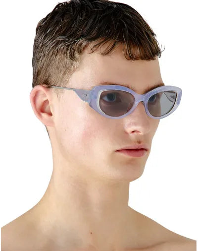 Diesel light blue oval sunglasses on face, side profile