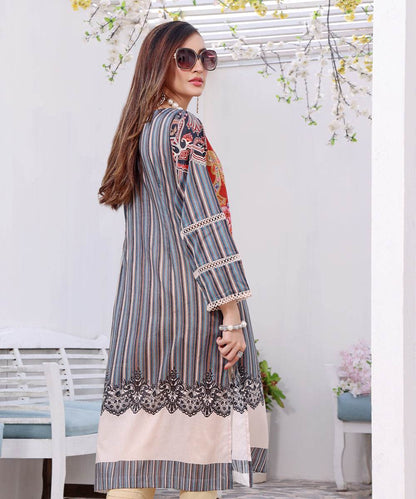 Side-view long tunic dress with blue stripe pattern, floral accents, and cuff trim