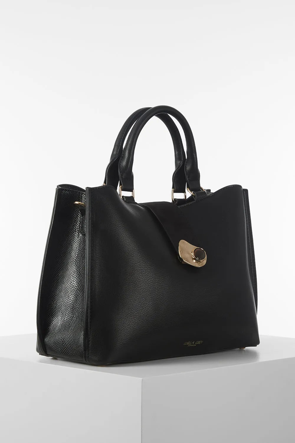 Black handbag with two top handles and front clasp detail, structured silhouette