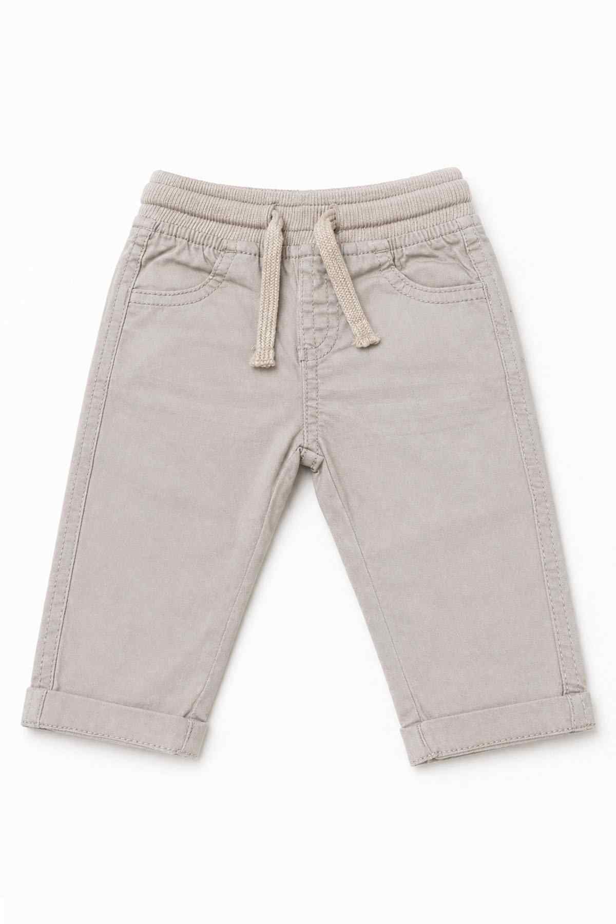 Beige baby pants with elastic waist, drawstring tie, and two front patch pockets