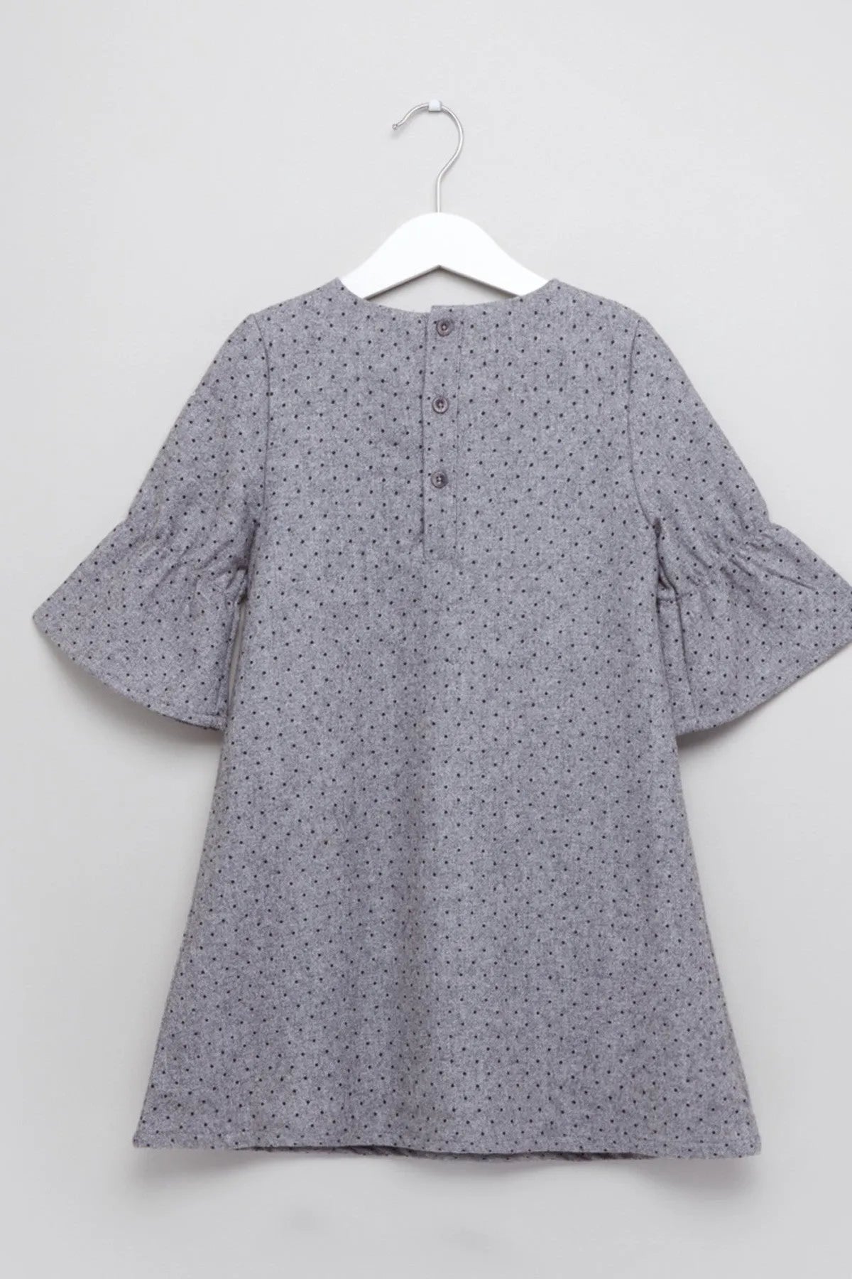Baby dress, light gray dotted back with center buttons and wide bell sleeves