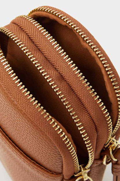 Accessorize tan crossbody bag interior close-up with twin zip compartments