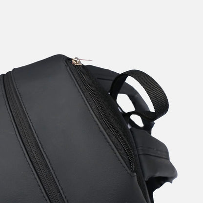 Black zipper and front pocket detail on small backpack with webbing shoulder strap