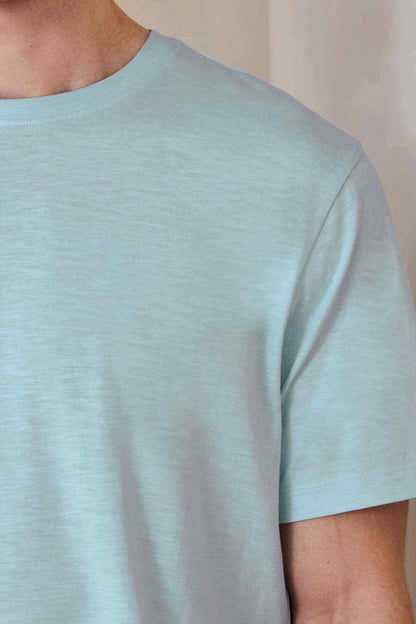 Light blue crew-neck T-shirt, close-up of shoulder and collar