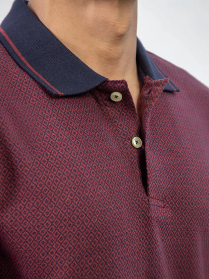 Close-up of maroon polo collar and front placket with navy trim and buttons