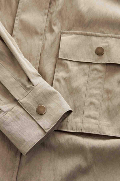 Khaki green jacket fabric with flap pocket detail and round button
