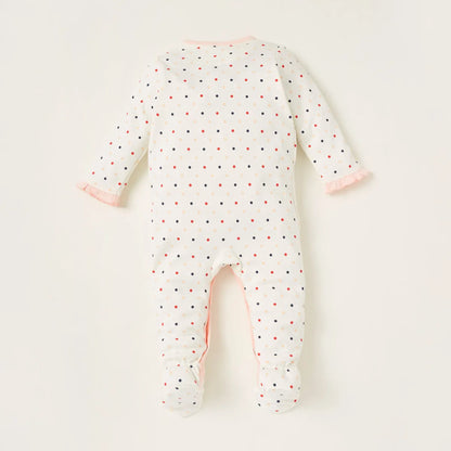 White baby footless romper with multicolor dots and pink-trim back opening