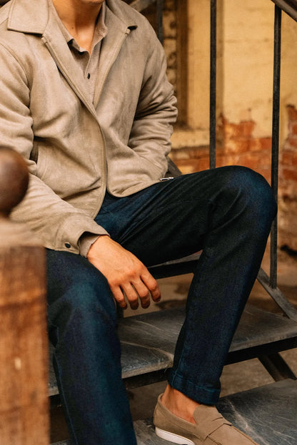 Dark blue jeans, relaxed straight fit with visible belt loops and cuffed hem