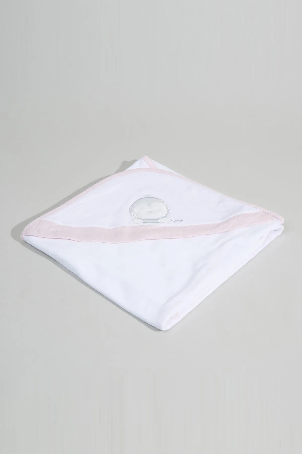 White baby hooded towel with pink trim and round applique