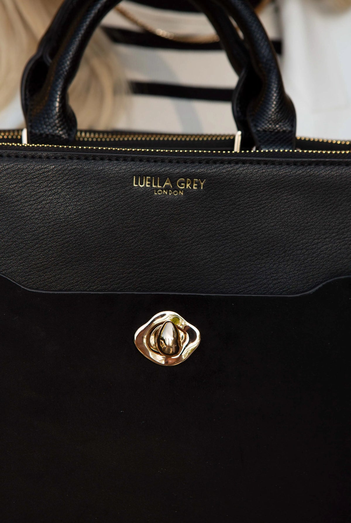 Black Luella Grey handbag with gold twist-lock front and top handles