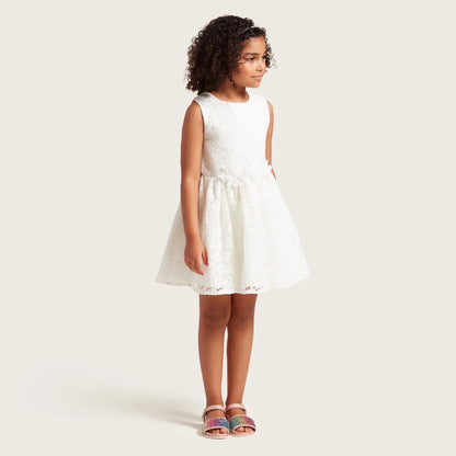 White sleeveless baby dress with rose print and gathered waist, back view
