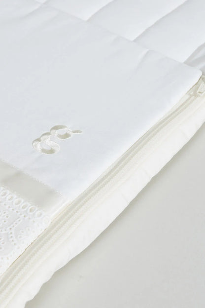 BABYSHOP cream swaddle blanket close-up with stitched trim and small applique