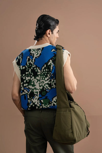 Back view of blue sleeveless patterned sweater vest with V-neck and white trim