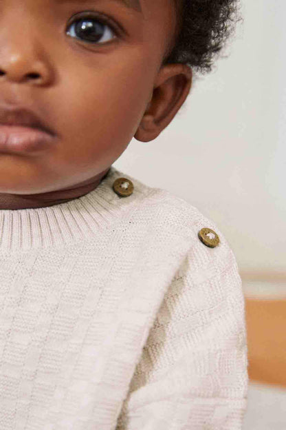 Baby knit sweater with textured fabric and gold-tone shoulder buttons