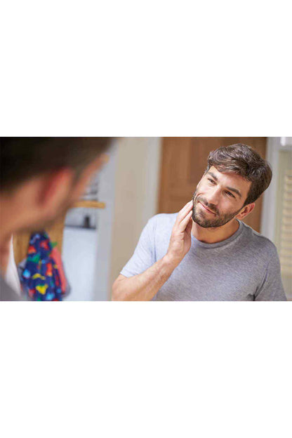 PHILIPS black trimmer in use on a man’s face and sideburn area
