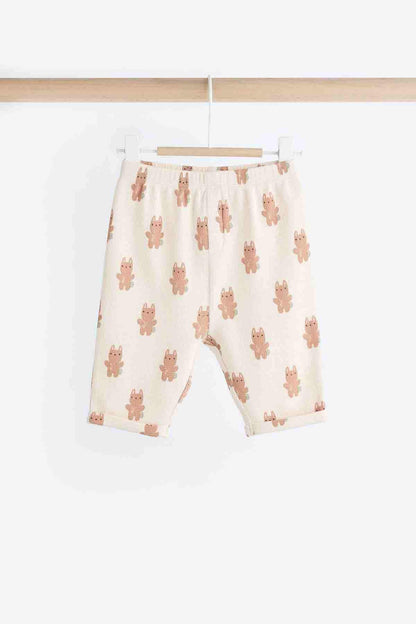 Cream shorts with allover bunny print and elastic waistband, hanging