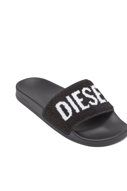Black slide sandals with fuzzy strap and white DIESEL logo across top