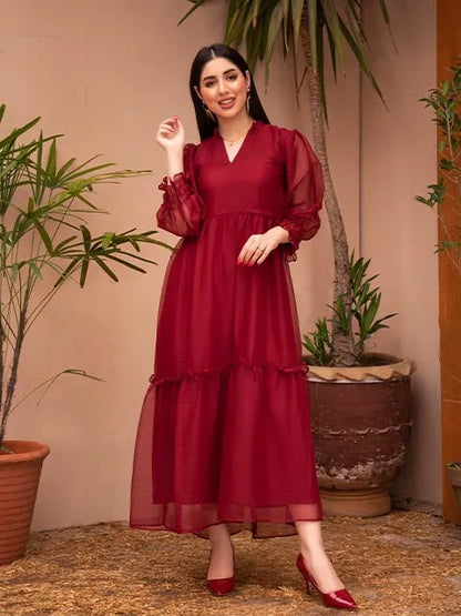 Deep red tiered midi dress with V-neck and sheer ruffle sleeves, smiling side pose.