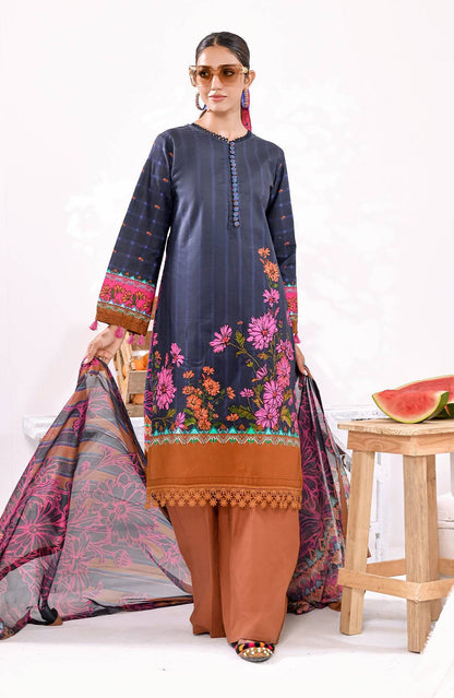Long embroidered tunic in dark navy with floral hem and multicolor details; brown pants