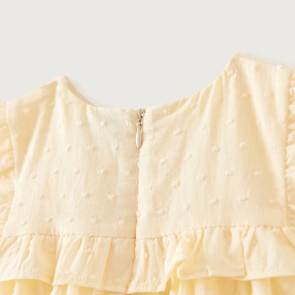 Baby dress back view in light yellow with keyhole zipper and ruffled waist hem