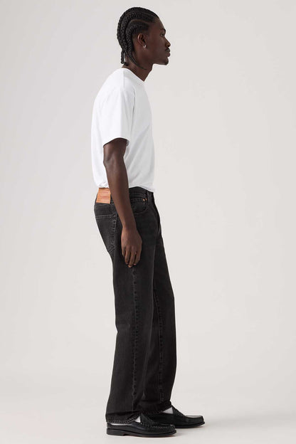 Levi's black denim jeans with straight leg and orange logo patch at waistband