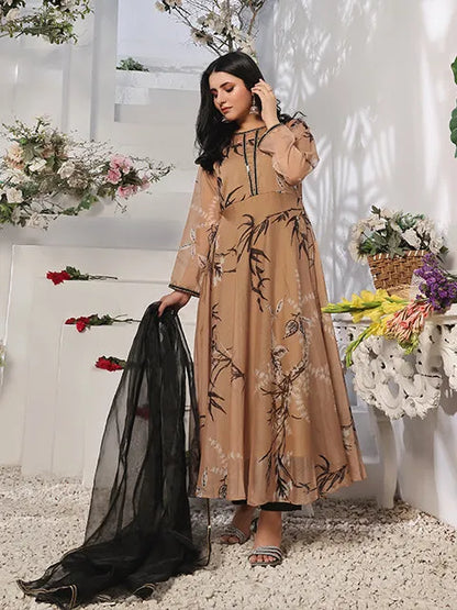 Tan printed maxi dress with long sleeves and black sheer dupatta trailing behind