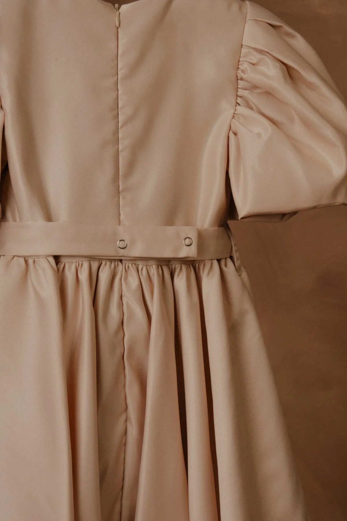 Beige dress bodice with button front, elastic waist, and gathered skirt detail