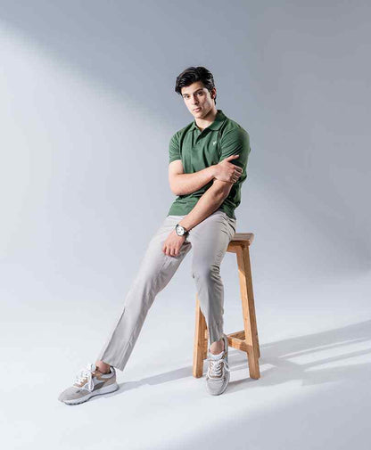 Fitted dark green polo shirt with short sleeves and collar, button front.