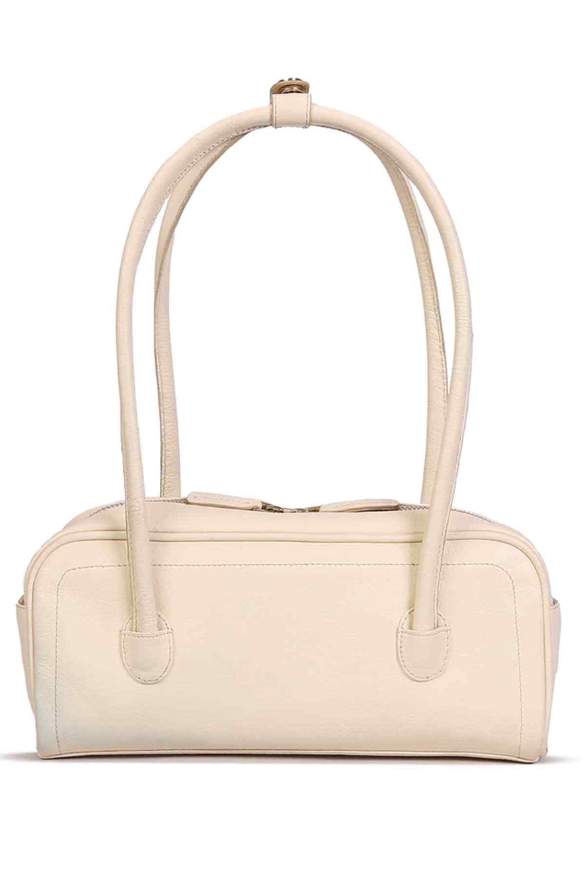 Ivory handbag with top handles, front pocket, and zip closure