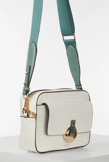 White crossbody handbag with teal adjustable straps, front flap and gold hardware
