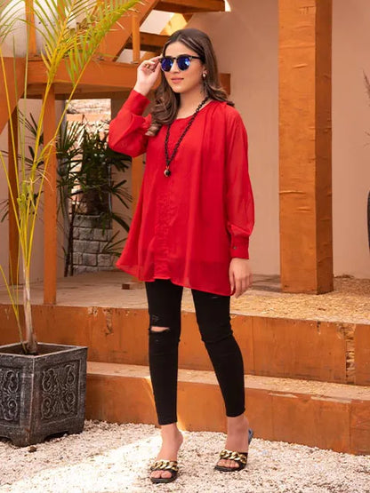 Nazmina red long tunic with round neck and long sleeves, black ripped skinny jeans