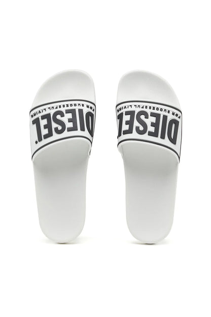 White slide sandals with black DIESEL lettering on instep