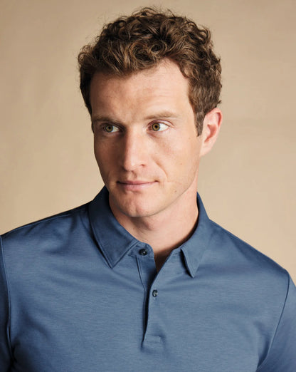 Blue polo shirt with buttoned collar and placket detail